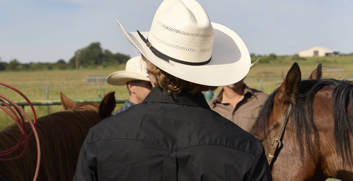 A man wearing a straw cowboy hat.